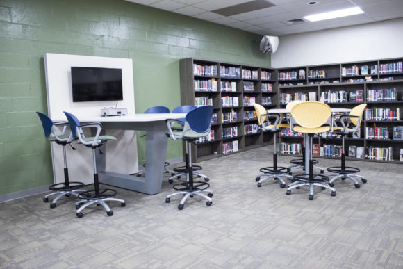 school library with collaborative media table and shelves
